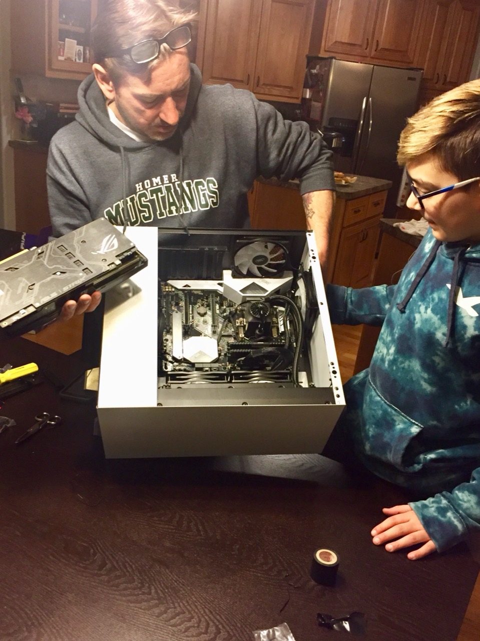 Building a computer together: parts on the table, a case open, and the work in progress.